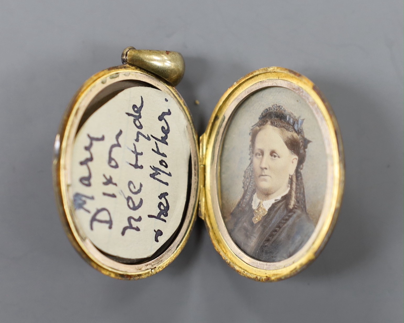 A late Victorian yellow metal, turquoise and seed pearl set oval locket, overall 48mm, gross weight 16.2 grams.